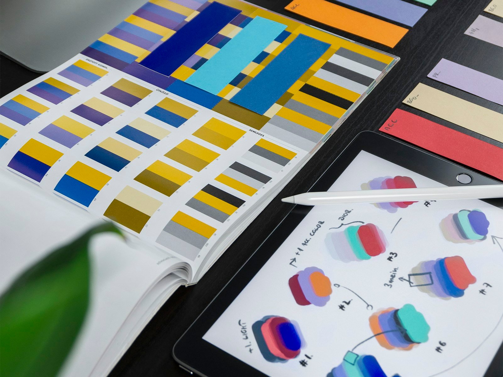 Color studies and interface sketches on a design desk